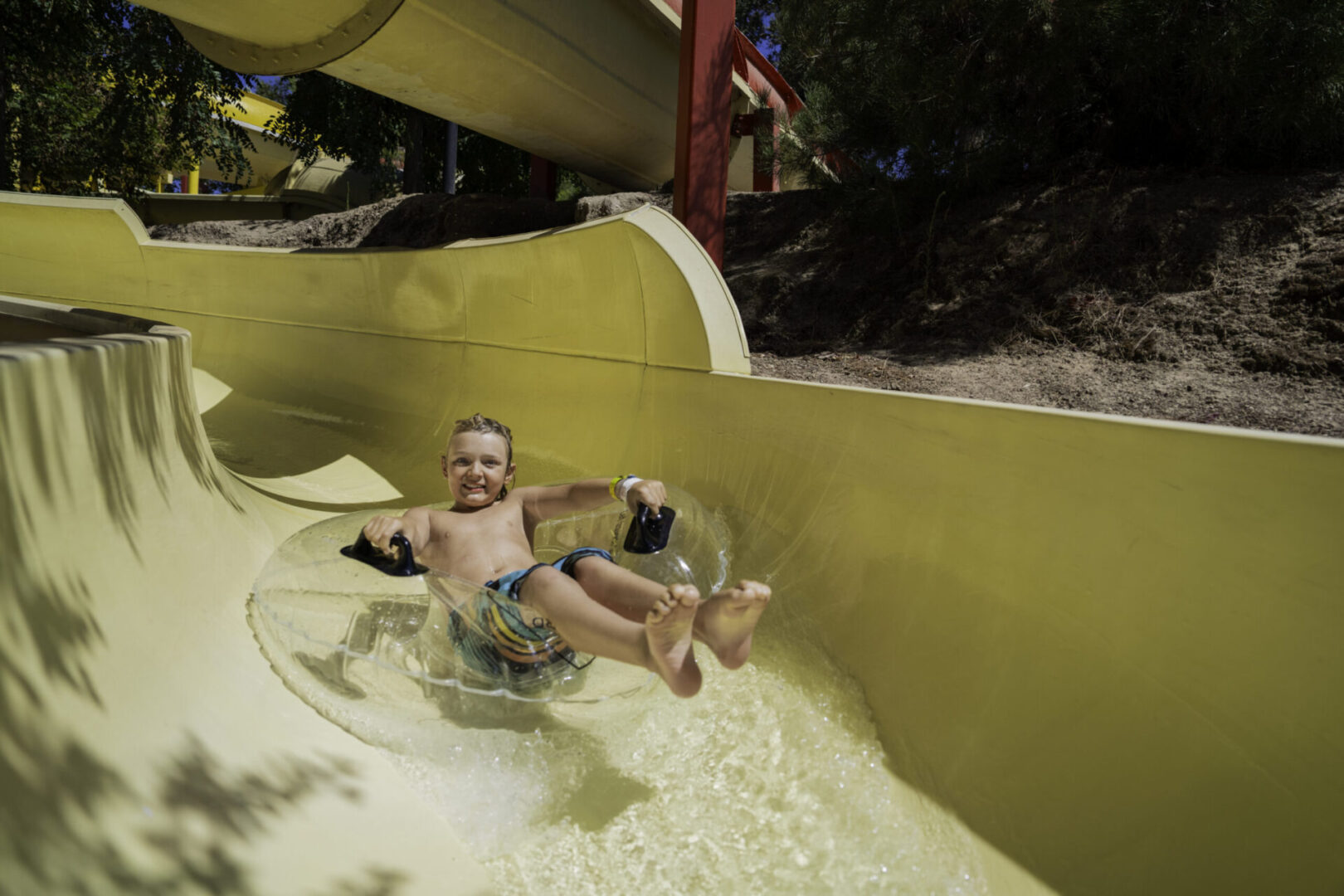 Boy enjoying water slide ride