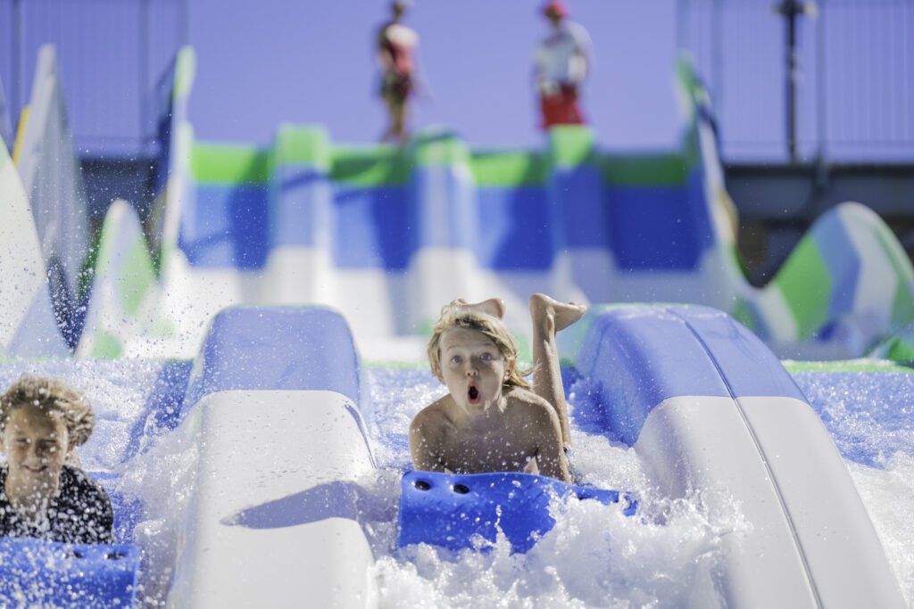 Kids splashing on a water slide
