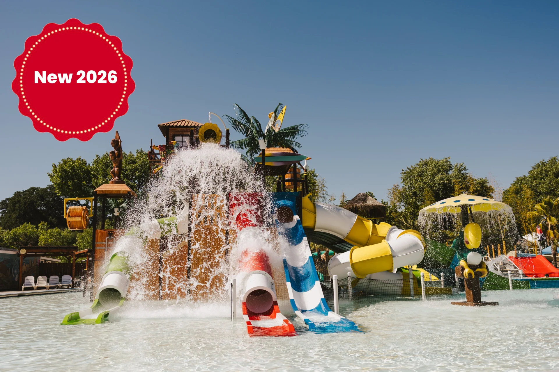 Colorful water slides and splash features at a sunny water park.