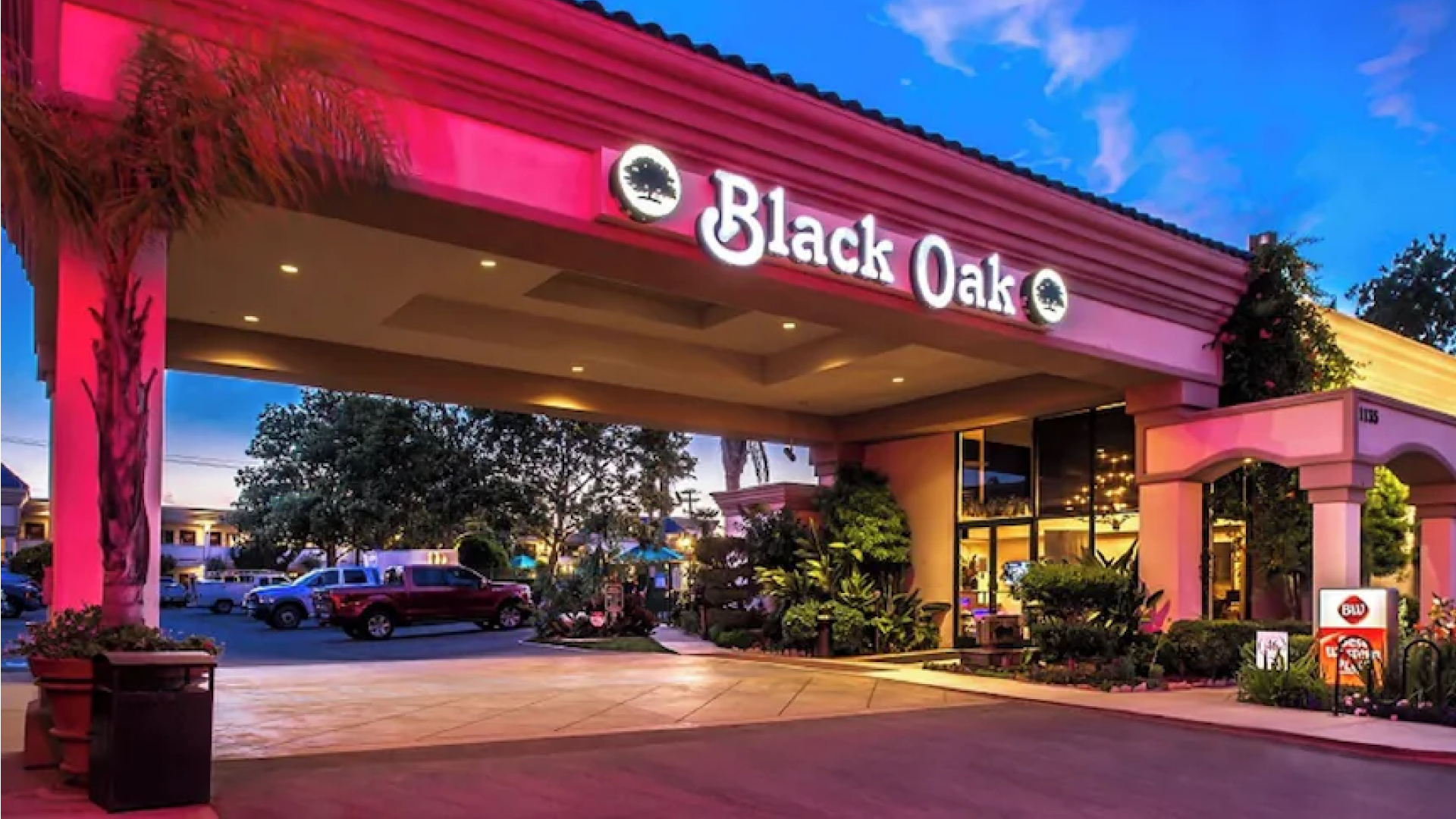 Exterior view of Black Oak restaurant entrance under a blue sky.