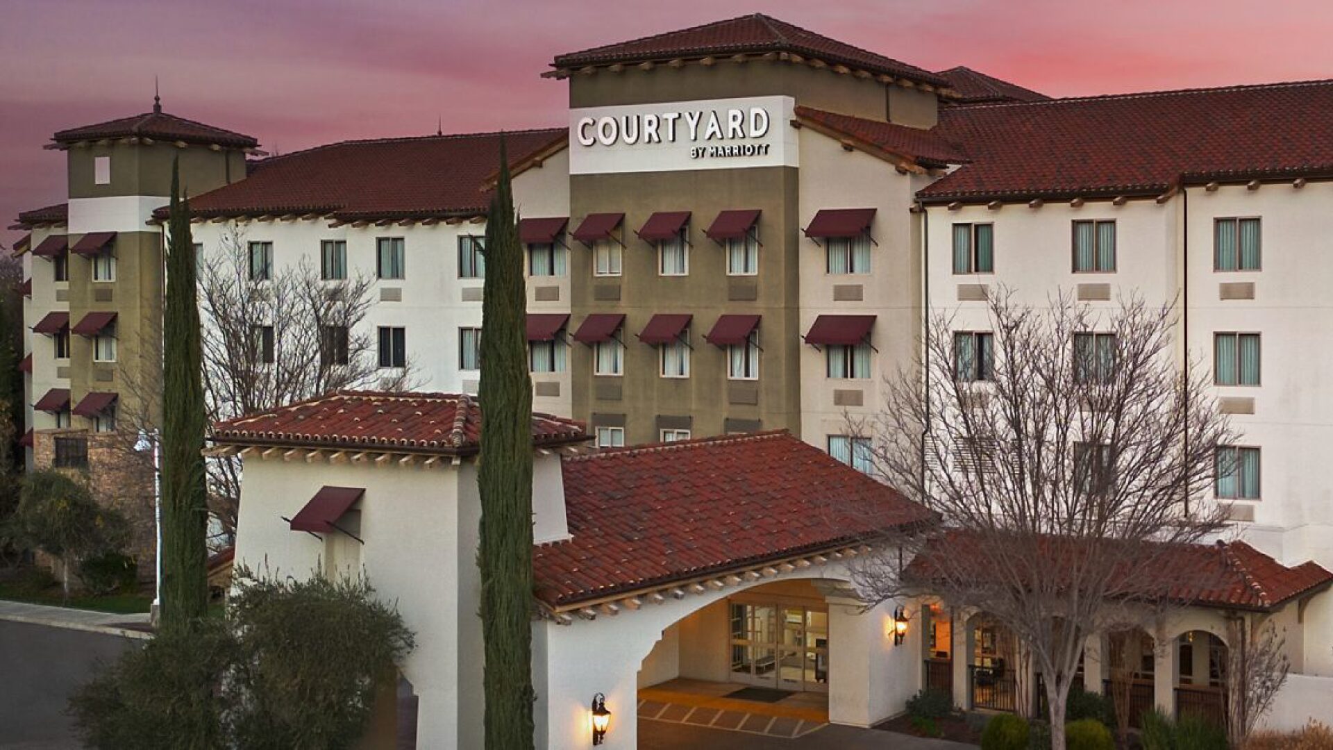 Exterior of the Courtyard by Marriott hotel at dusk.