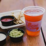 Drink with chips, salsa, and guacamole.