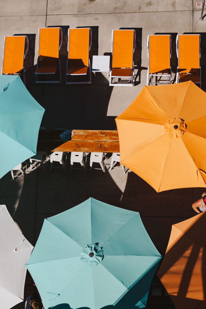 Colorful umbrellas and sun loungers by pool.